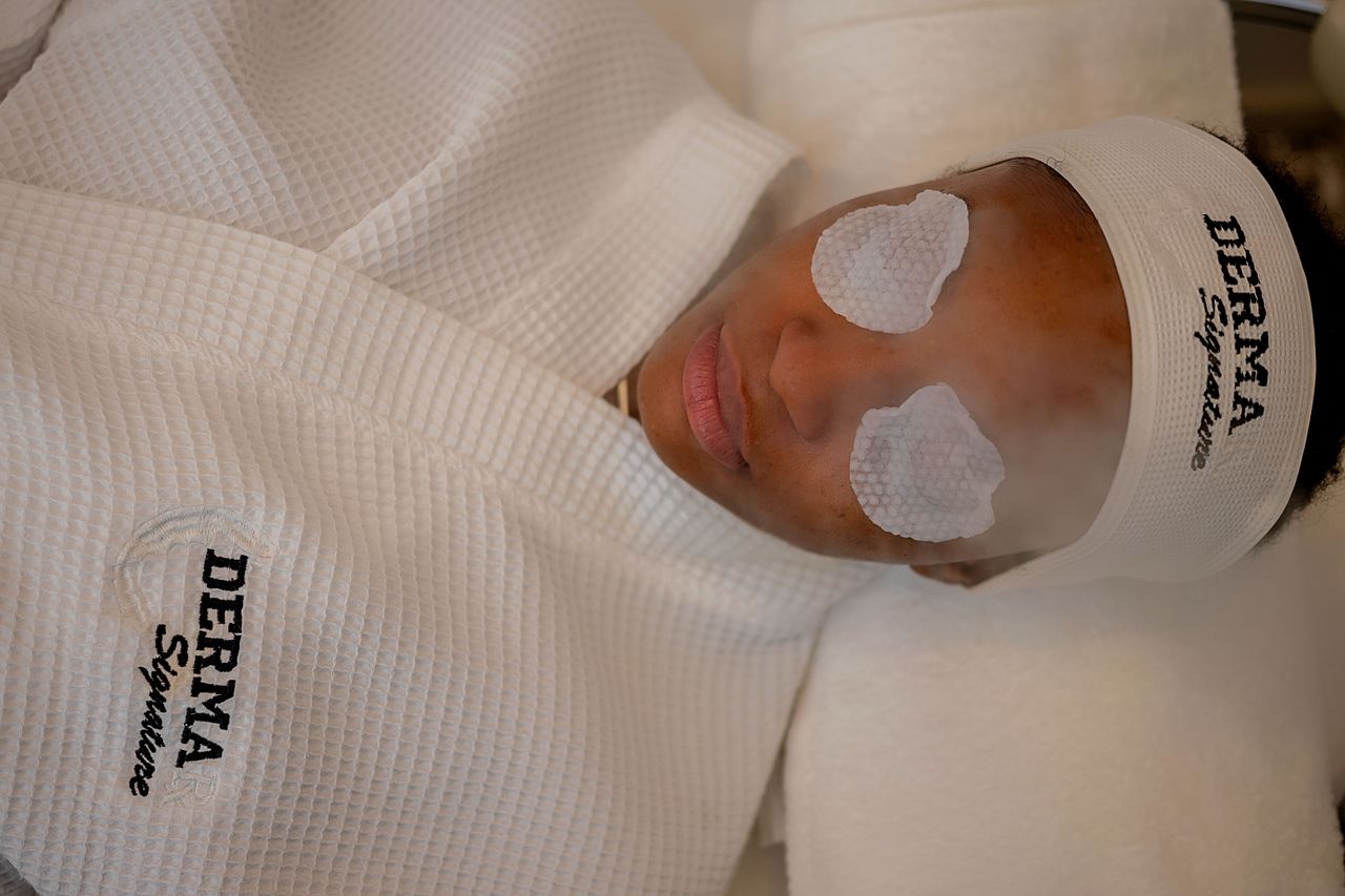A woman enjoys a relaxing facial treatment at Derma Signature spa in Abuja, Nigeria.