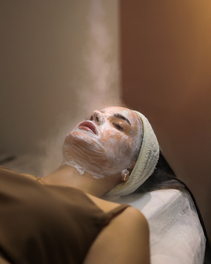Serene spa session with a facial mask and steam treatment for skin rejuvenation in Istanbul's beauty clinic.